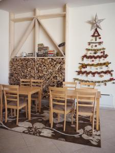 パンポロボにあるElit Pamporovo Apartmentsのテーブルと椅子付きの部屋のクリスマスツリー