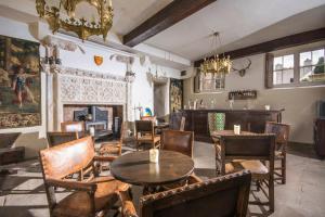 a living room with tables and chairs and a fireplace at Appleby Castle in Appleby