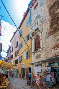 a group of girls walking down a street in a city at Casa Kaligari history in Rovinj