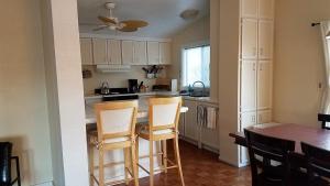 a kitchen with white cabinets and a table and chairs at Shoshone RV Park in Shoshone
