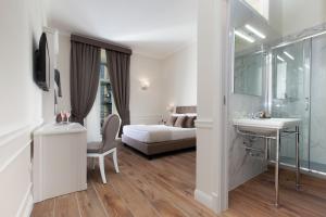 Posteľ alebo postele v izbe v ubytovaní La Fontanina Suites