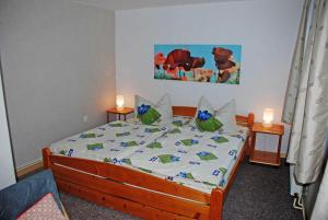 a bedroom with a bed with two candles on it at Ferienwohnungen am Heideweg in Baabe