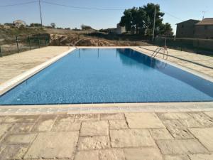 a large swimming pool with blue water at La Rectoria in Coscó 