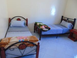 
A bed or beds in a room at Taghazout Holidays
