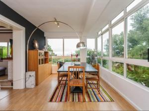 a dining room with a table and some windows at Chalet con piscina privada in Las Villas