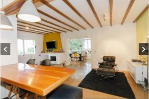a living room with a wooden table and chairs at Chalet con piscina privada in Las Villas
