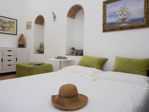 a bedroom with two beds with a hat on the bed at Casa Almagio - Atrani Amalfi coast - terrace & seaview in Atrani