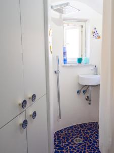 a small bathroom with a sink and a toilet at Casa Almagio - Atrani Amalfi coast - terrace & seaview in Atrani