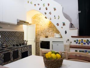 a kitchen with a basket of fruit on the counter at Casa Almagio - Atrani Amalfi coast - terrace & seaview in Atrani
