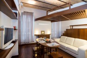 a living room with a white couch and a table at Trevi Fountain - Lovely Loft Apartment in Rome