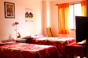a room with two beds and a window at Hotel Frontera in La Quiaca +30 photos