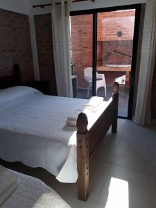 a bedroom with a bed and a view of a patio at Los Cardenales in Santa Ana