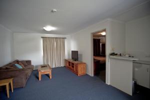 a hotel room with a bed and a television at Centrepoint Motor Inn in Rockhampton