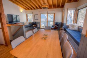 a dining room with a wooden table and chairs at Drovers Rest in Dinner Plain