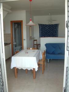 a room with a bed, table, chairs and a lamp at La Salina in Lampedusa