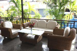 a living room with a couch and chairs and a table at Cha Am Perfect in Cha Am