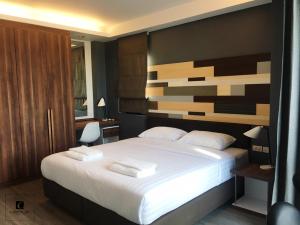 מיטה או מיטות בחדר ב-Campagne Hotel and Residence - SHA Plus