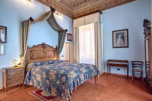 a bedroom with a bed with a canopy at Villa Graziani in Vada