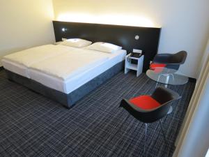 Postel nebo postele na pokoji v ubytování Comfor Hotel Ulm City