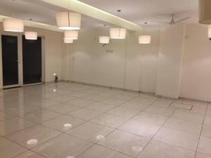 a large room with white walls and white tile floors at Lotus Grand Akm in Kālka