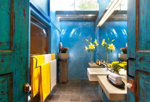 a bathroom with two sinks and a blue wall at Dickman Resort "The Boutique Hotel" in Negombo