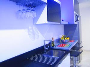 a blue kitchen with a sink and a counter at Happy Home Premium in Playa del Ingles