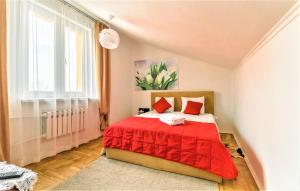a bedroom with a red bed and a window at Izuminka v Centre Goroda in Lviv