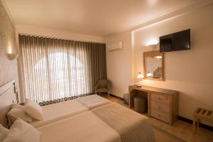 Un pat sau paturi într-o cameră la Hotel Melius