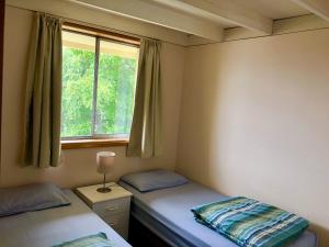 a bedroom with two twin beds and a window at Narrara Backpackers Hobart in Hobart