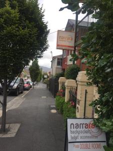 a row of street signs sitting on the side of a road at Narrara Backpackers Hobart in Hobart