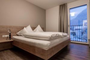 a bedroom with a bed and a large window at Appartements Ausblick in Sankt Gallenkirch