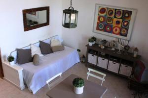 a bedroom with a bed and a table and a painting at Rais Gerbi Appartamento in Pollina