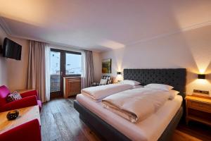 Postel nebo postele na pokoji v ubytování Hotel Garni Edelweiss