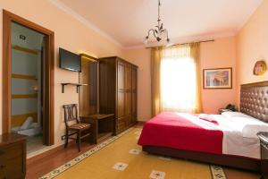 a bedroom with a red bed and a window at Anthony Guesthouse in Rome