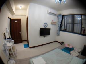 a view of a living room with a tv at Lan-inn in Yujing