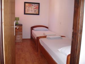 a small room with two beds and a mirror at Brko Apartment in Medulin