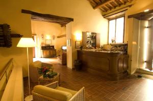 a large living room with a counter and a table at Castello Di Gargonza in Monte San Savino