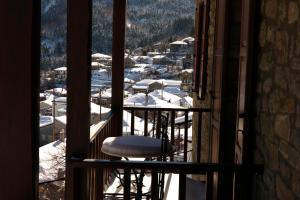 a view of a snowy mountain from a window at Kannaveiko in Ano Chora