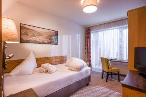 Voodi või voodid majutusasutuse Alpen Glück Hotel Kirchberger Hof toas