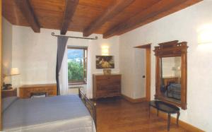 a bedroom with a blue bed and a mirror at Villa San Domenico in Morano Calabro