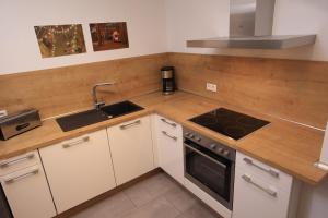 a kitchen with a sink and a stove at 1Step2AllCities House&Garden in Wuppertal