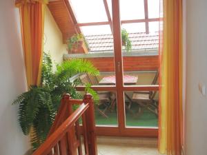 a room with a balcony with a table and chairs at Villa Elena in Smižany