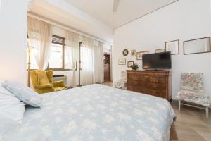 a bedroom with a bed and a flat screen tv at Cristina Rossi Bed&Breakfast in Bologna