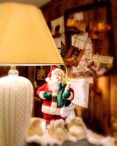 a santa claus figurine on a table next to a lamp at Hotel Chalet La Meridiana in Saint-Pierre