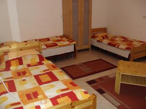 a room with three beds and rugs in it at Erik Apartments in Budapest