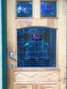 a door with a stained glass window on it at Narrara Backpackers Hobart in Hobart