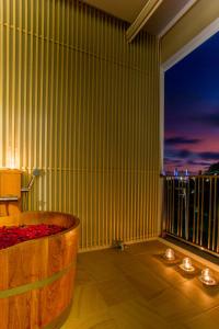 a bathroom with a tub and a large window at LaRio Hotel Krabi-SHA Extra Plus in Ao Nang Beach