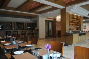 a restaurant with tables and chairs and a bar at Gakyil Thimphu in Thimphu