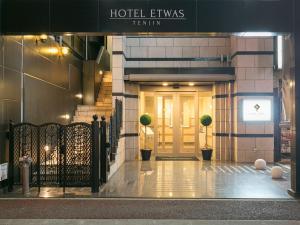 a hotel entry to a building with a door at Hotel Etwas Tenjin in Fukuoka