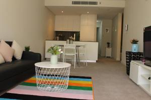 a living room with a couch and a table at Exquisite Family Home +Parking, Close to CBD in Sydney